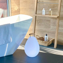 Load image into Gallery viewer, Vessel Bluetooth Outdoor LED Table Lamp in bathroom.
