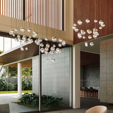Load image into Gallery viewer, Grapes® 24-Light Round LED Multipoint Pendant Light in living room.
