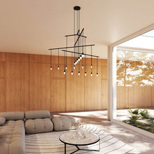 Load image into Gallery viewer, Suspenders® 4-Tier Tri-Bar LED Pendant Light in living room.
