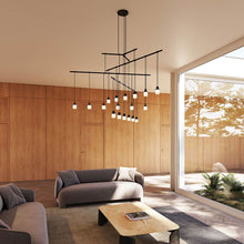 Load image into Gallery viewer, Suspenders® 4-Tier Tri-Bar LED Pendant Light in living room.
