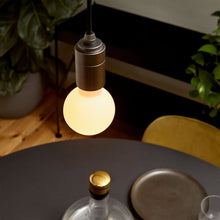 Load image into Gallery viewer, Sphere II Medium Base G24 Type LED Bulb in living room.
