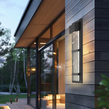 Load image into Gallery viewer, Sol Outdoor LED Wall Light in Outside Area.
