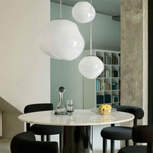 Load image into Gallery viewer, Melt Trio Round LED Pendant Light in living room.
