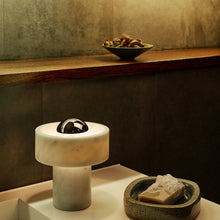 Load image into Gallery viewer, Stone LED Portable Table Lamp in bathroom.
