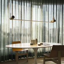 Load image into Gallery viewer, Nastro LED Pendant Light in living room.
