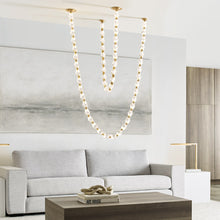 Load image into Gallery viewer, Collier LED Chandelier in living room.

