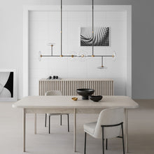 Load image into Gallery viewer, Calvino Linear LED Pendant Light in dining room.
