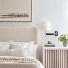 Load image into Gallery viewer, Elle LED Swing Arm Wall Light in bedroom.
