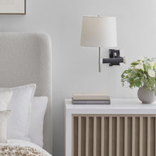 Load image into Gallery viewer, Elle LED Swing Arm Wall Light in bedroom.
