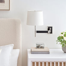Load image into Gallery viewer, Elle LED Swing Arm Wall Light in bedroom.
