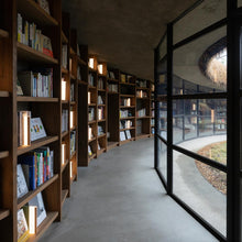 Load image into Gallery viewer, Nightbook LED Table Lamp in library.
