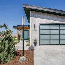 Load image into Gallery viewer, Aura Outdoor Lean Post Light in Outside Area.
