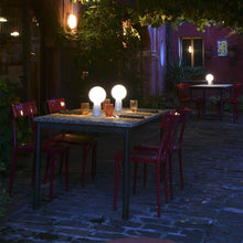 Load image into Gallery viewer, Olimpia LED Table Lamp in Outside Area.
