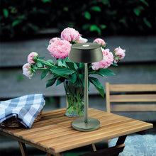 Load image into Gallery viewer, Sister LED Portable Table Lamp in Outside Area.
