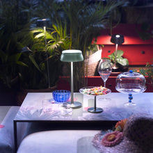 Load image into Gallery viewer, Sister LED Portable Table Lamp in Outside Area.
