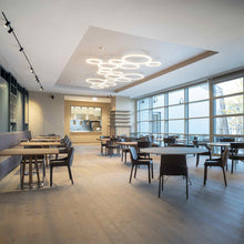 Load image into Gallery viewer, Ripple LED Cluster Pendant Light in restaurant.
