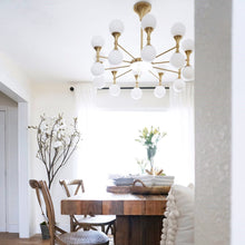 Load image into Gallery viewer, Astoria LED Chandelier in dining room.
