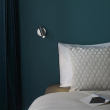 Load image into Gallery viewer, Enna Round LED Wall Light in bedroom.
