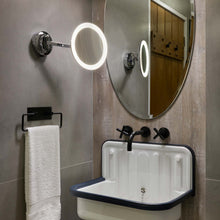 Load image into Gallery viewer, Mascali Round LED Magnifying Mirror in bathroom.
