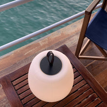 Load image into Gallery viewer, Misko Camp LED Table Lamp in Outside Area.
