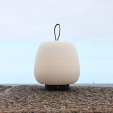 Load image into Gallery viewer, Misko Camp LED Table Lamp in Outside Area.
