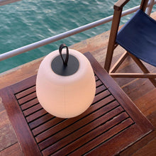 Load image into Gallery viewer, Misko Camp LED Table Lamp in Outside Area.

