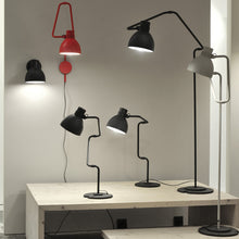 Load image into Gallery viewer, Blux System T Table Lamp in exhibition.

