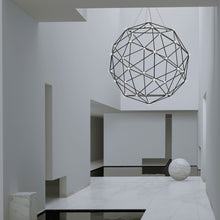 Load image into Gallery viewer, Constellation® Hedron LED Pendant Light in living room.
