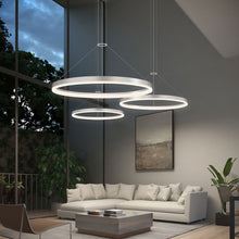 Load image into Gallery viewer, Corona Ring LED Pendant Light in living room.

