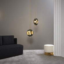 Load image into Gallery viewer, Pendulum LED Pendant Light in living room.
