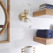 Load image into Gallery viewer, Helios Wall Light in bathroom.
