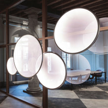 Load image into Gallery viewer, Discovery LED Vertical Suspension Light in living room.
