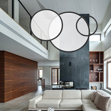 Load image into Gallery viewer, Discovery LED Vertical Suspension Light in living room.
