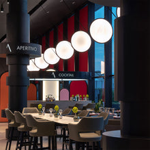 Load image into Gallery viewer, Discovery LED Vertical Suspension Light in restaurant.
