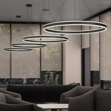 Load image into Gallery viewer, Double Corona™ Ring LED Pendant Light in living room.
