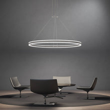 Load image into Gallery viewer, Double Corona™ Ring LED Pendant Light in living room.
