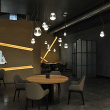 Load image into Gallery viewer, Empatia LED Suspension Light in living room.
