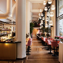 Load image into Gallery viewer, Empatia LED Suspension Light in restaurant.
