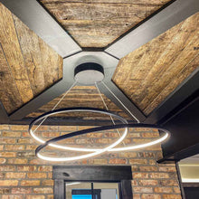 Load image into Gallery viewer, Cycle LED Pendant Light in living room.
