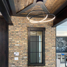 Load image into Gallery viewer, Cycle LED Pendant Light in living room.
