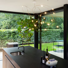 Load image into Gallery viewer, Flock of Light LED Chandelier in dining room.

