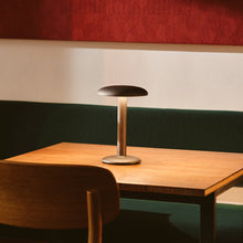 Load image into Gallery viewer, Gustave LED Table Lamp in restaurant.
