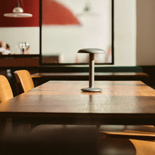 Load image into Gallery viewer, Gustave LED Table Lamp in restaurant.
