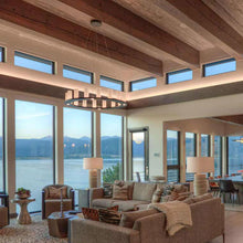 Load image into Gallery viewer, Corona Ring LED Chandelier in living room.
