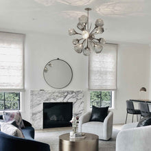 Load image into Gallery viewer, Gem Starburst LED Chandelier in living room.
