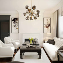 Load image into Gallery viewer, Gem Starburst LED Chandelier in living room.
