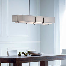 Load image into Gallery viewer, Exos Long Rectangular Pendant Light in dining room.
