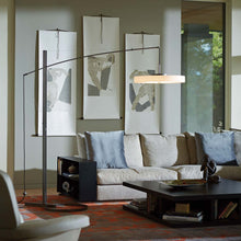 Load image into Gallery viewer, Disq Arc LED Floor Lamp in living room.
