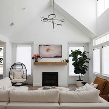Load image into Gallery viewer, Saturn LED Chandelier in living room.
