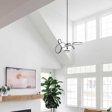 Load image into Gallery viewer, Saturn LED Chandelier in living room.
